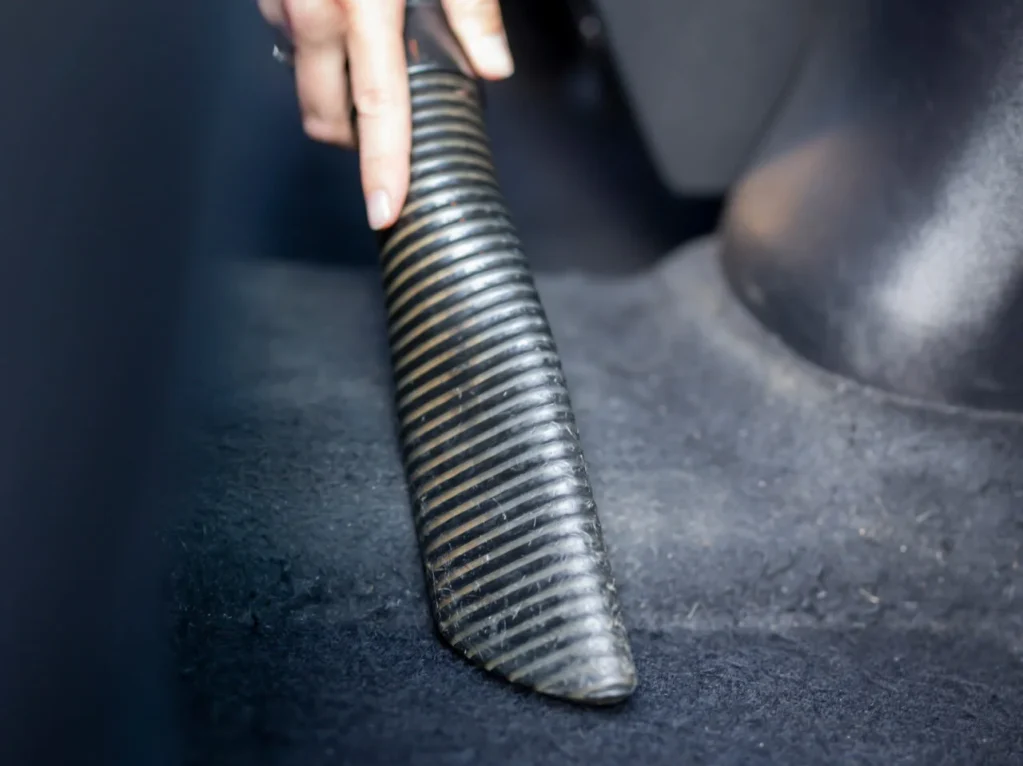 woman-vacuuming-car-interior-2023-11-27-05-17-30-utc-1.webp